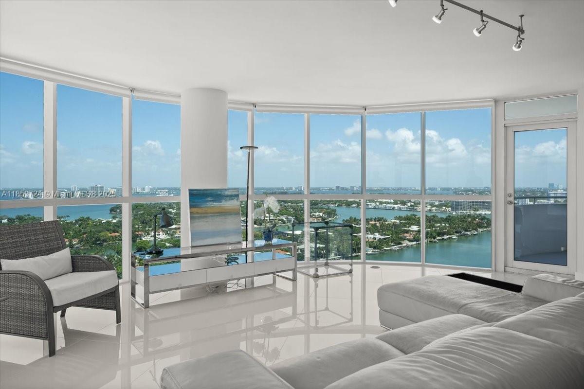 6301 Collins Avenue, Unit 2705 Miami Beach, FL 33141 - Photo 2 of 41 a living room with furniture and a floor to ceiling window