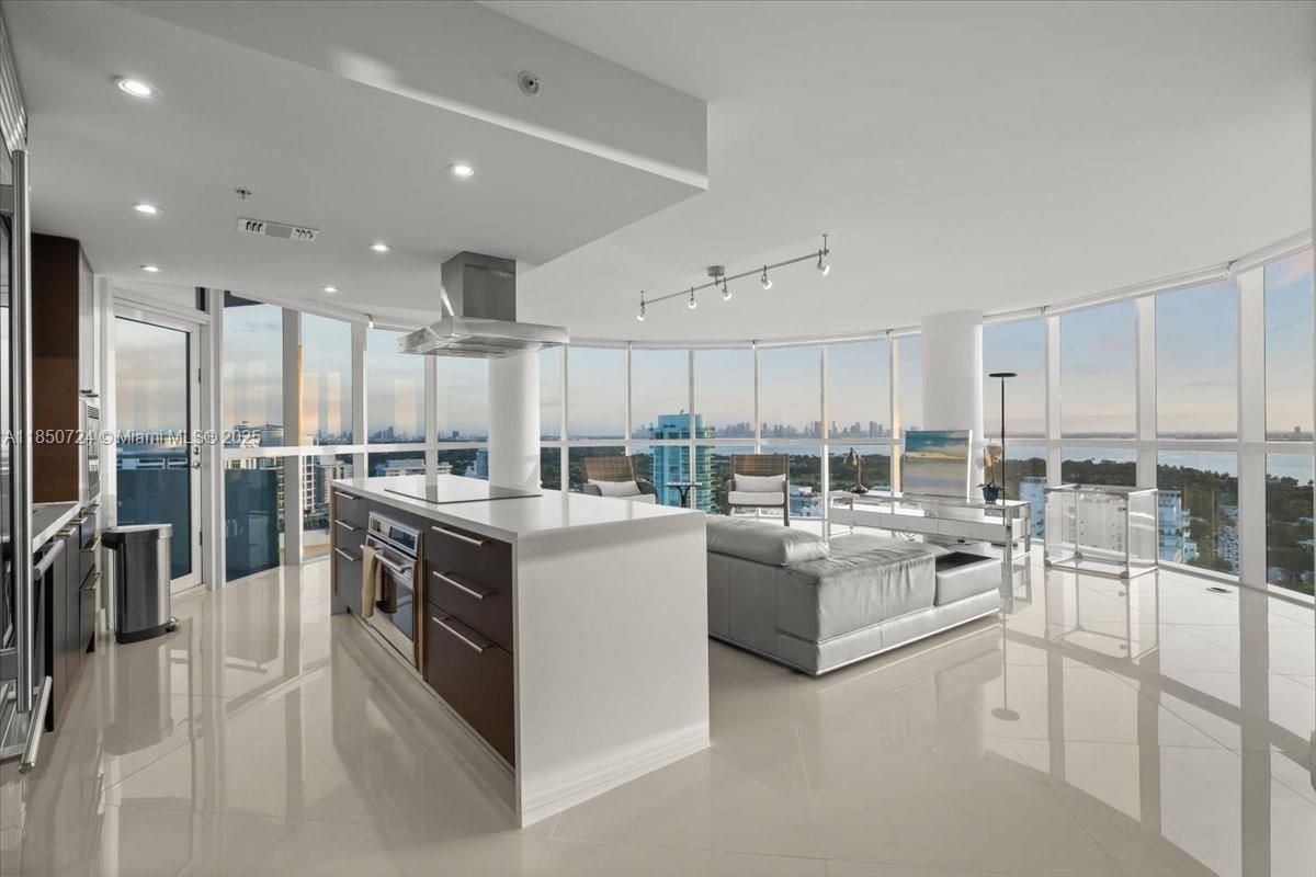 6301 Collins Avenue, Unit 2705 Miami Beach, FL 33141 - Photo 7 of 41 a kitchen with counter top space and stainless steel appliances