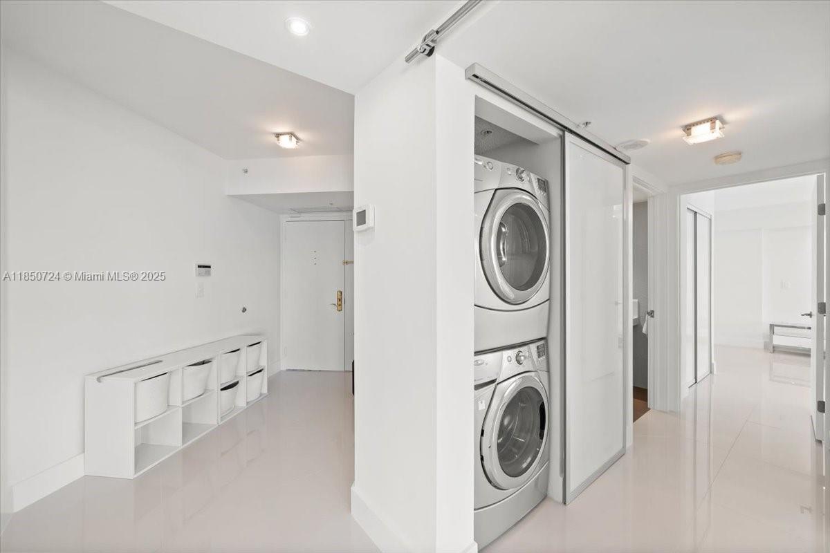 6301 Collins Avenue, Unit 2705 Miami Beach, FL 33141 - Photo 9 of 41 a view of a hallway with washer and dryer