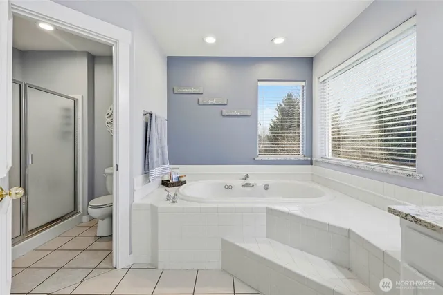 an aerial view of a swimming pool with outdoor seating