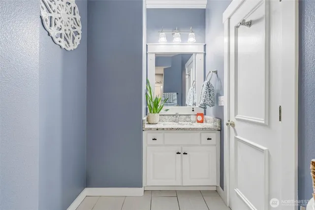 a utility room with granite countertop cabinets washer and dryer