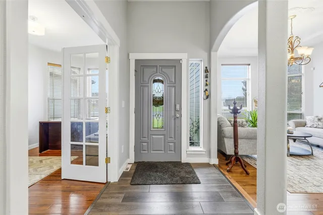 a view of a hallway with wooden floor and furniture