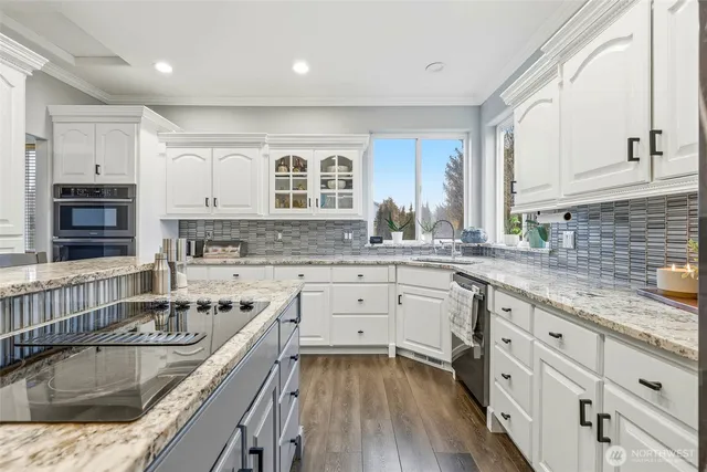 a dining room with furniture floor to ceiling window and wooden floor