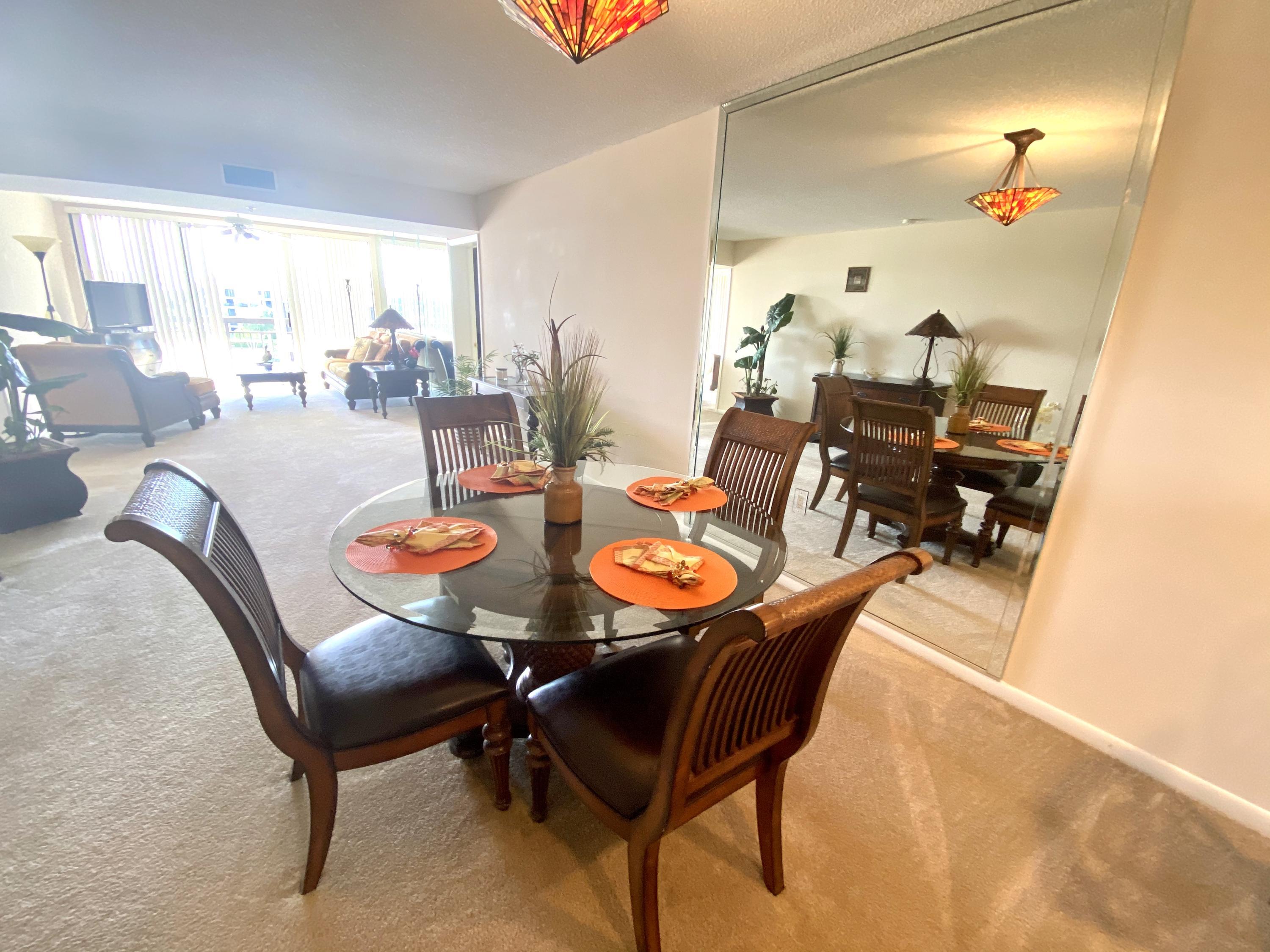2301 Marina Isle Way, Unit 503 Jupiter, FL 33477 - Photo 30 of 45 a dining room with furniture and a large window