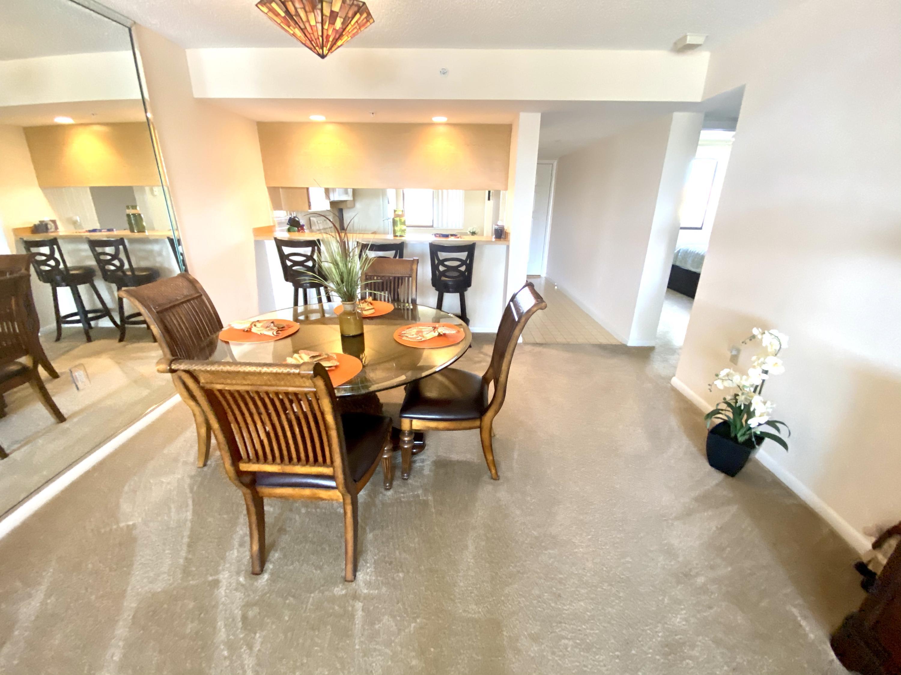 2301 Marina Isle Way, Unit 503 Jupiter, FL 33477 - Photo 33 of 45 a dining room with furniture and wooden floor