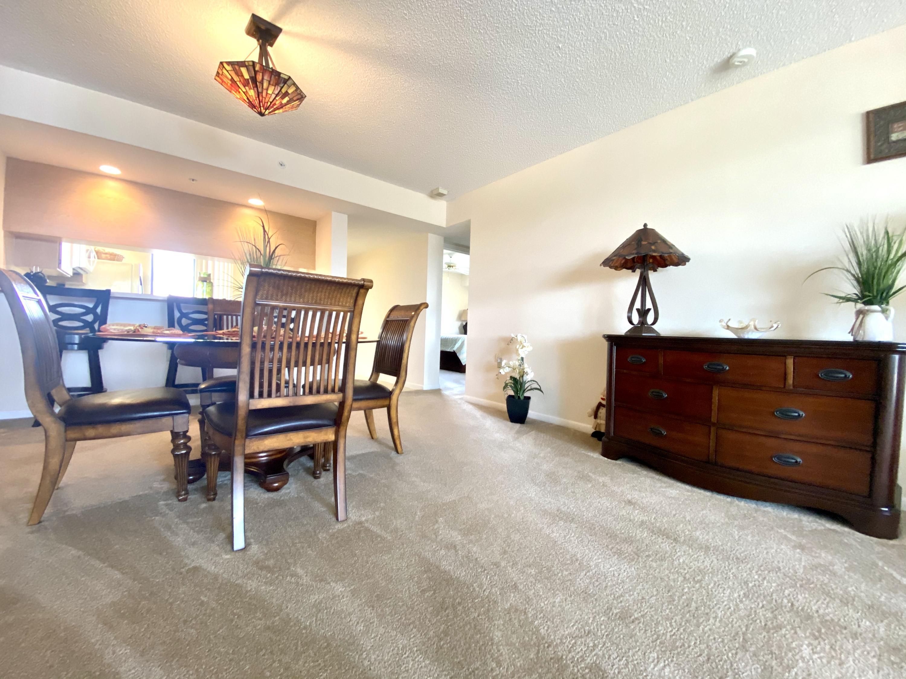 2301 Marina Isle Way, Unit 503 Jupiter, FL 33477 - Photo 35 of 45 a living room with a couch and a potted plant