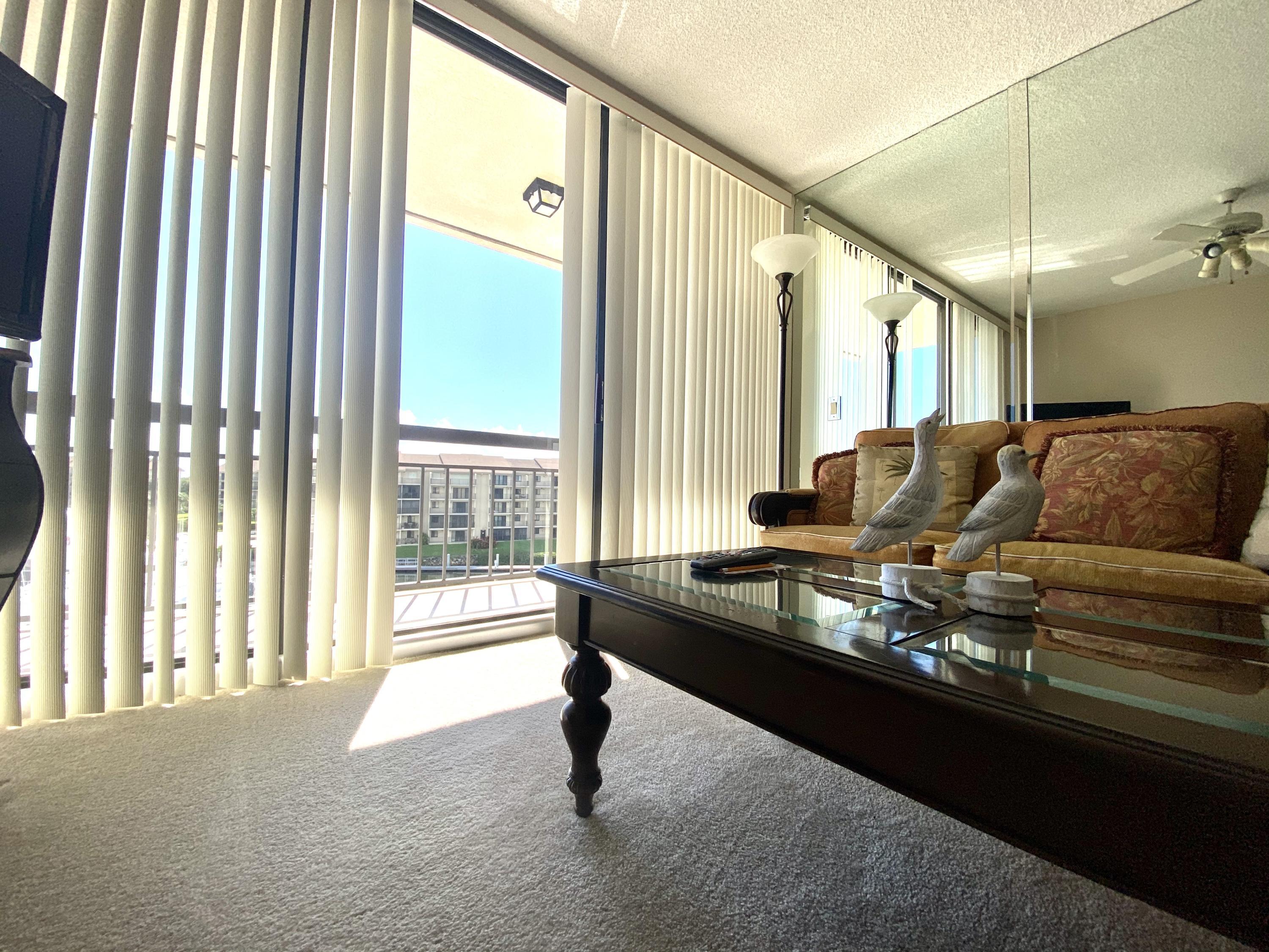 2301 Marina Isle Way, Unit 503 Jupiter, FL 33477 - Photo 36 of 45 a living room with furniture and a large window