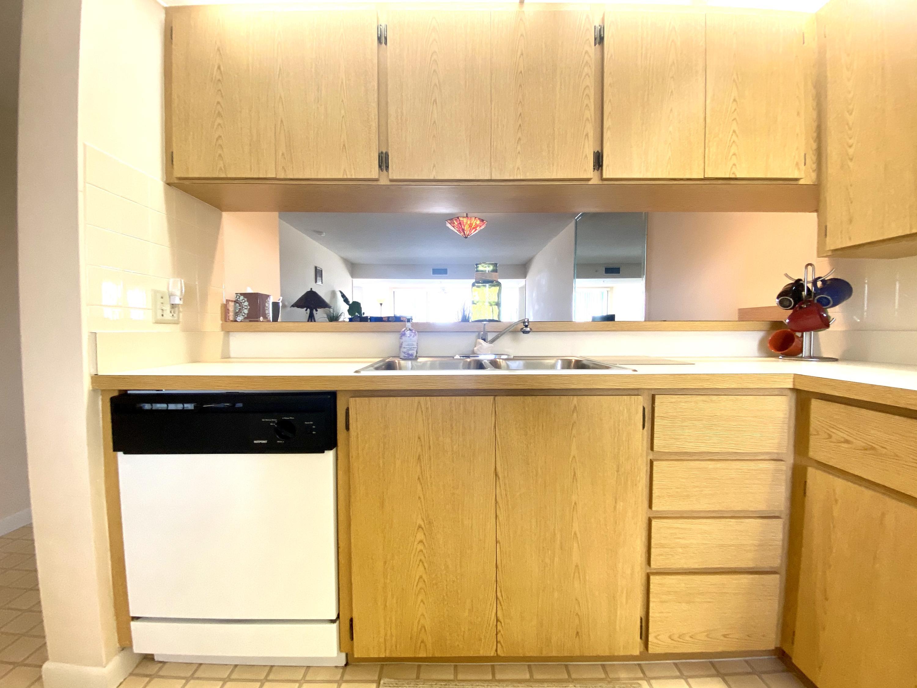 2301 Marina Isle Way, Unit 503 Jupiter, FL 33477 - Photo 8 of 45 a kitchen with a sink a cabinets and window