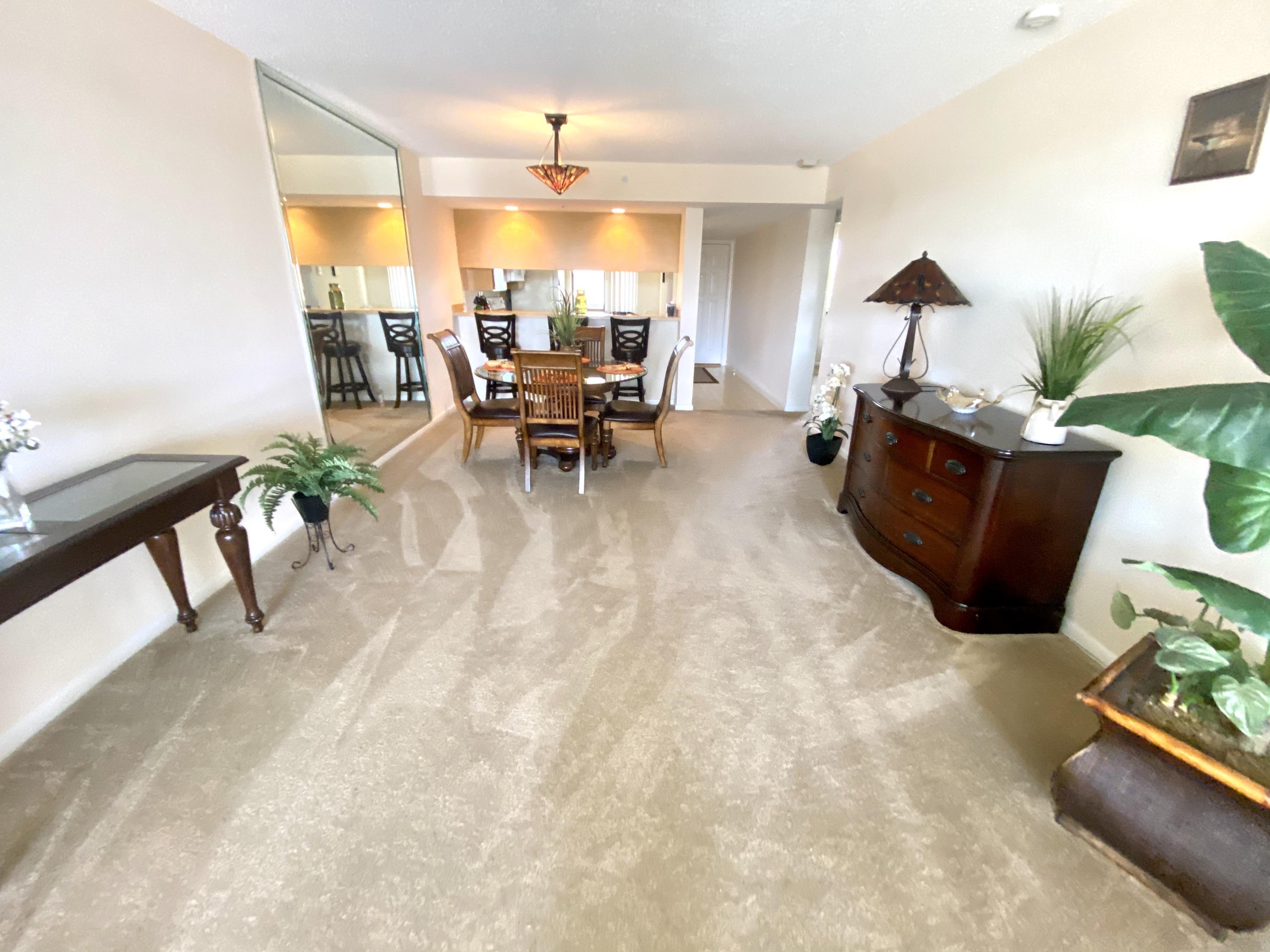 2301 Marina Isle Way, Unit 503 Jupiter, FL 33477 - Photo 10 of 45 a living room with furniture and a potted plant