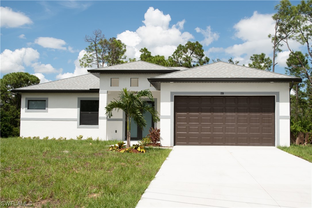 a front view of a house with a yard and garage