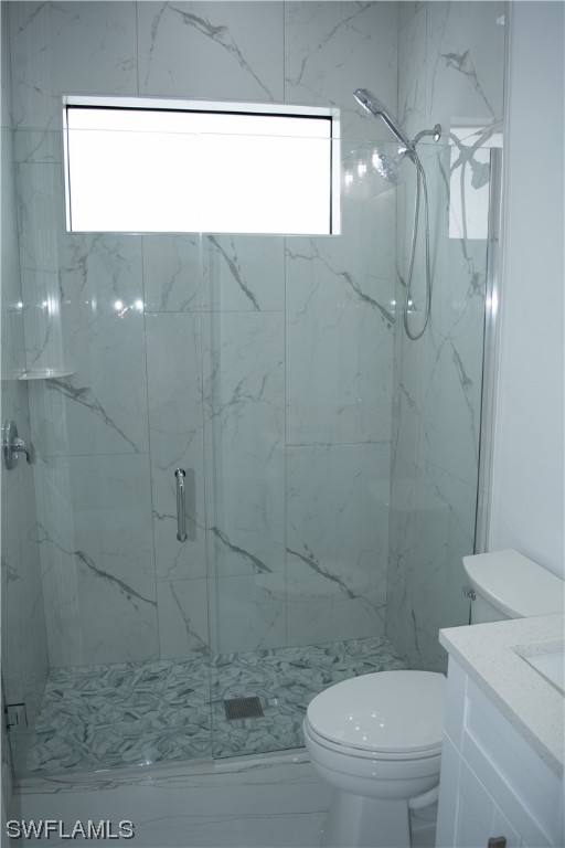 3718 41st Street Southwest Lehigh Acres, FL 33976 - Photo 17 of 28 a bathroom with a toilet a sink a shower and a mirror