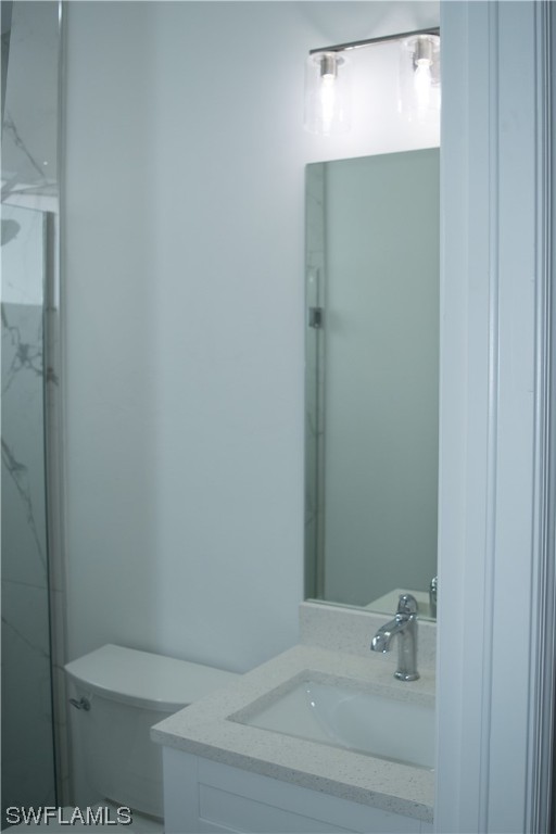 3718 41st Street Southwest Lehigh Acres, FL 33976 - Photo 18 of 28 a bathroom with a toilet and a sink