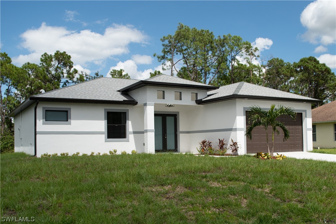 3718 41st Street Southwest Lehigh Acres, FL 33976 - Photo 2 of 28 a view of a front of house with a yard