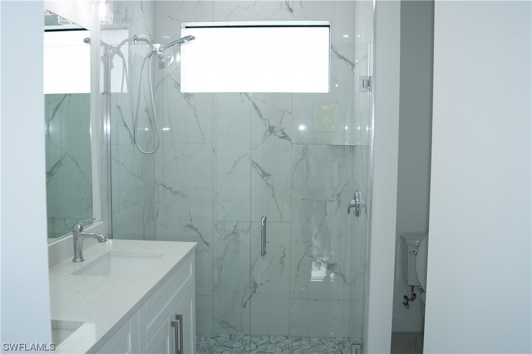 3718 41st Street Southwest Lehigh Acres, FL 33976 - Photo 24 of 28 a bathroom with a shower and a sink