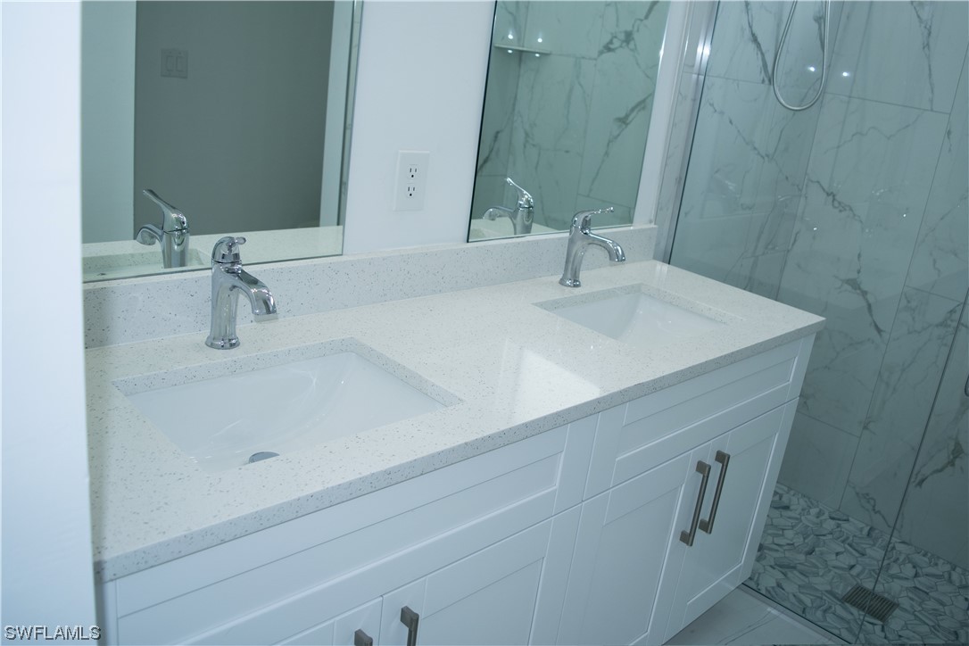 3718 41st Street Southwest Lehigh Acres, FL 33976 - Photo 25 of 28 a bathroom with a sink and a mirror