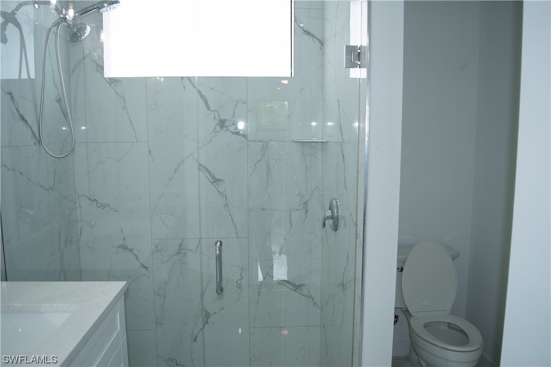 3718 41st Street Southwest Lehigh Acres, FL 33976 - Photo 26 of 28 a bathroom with a shower and toilet