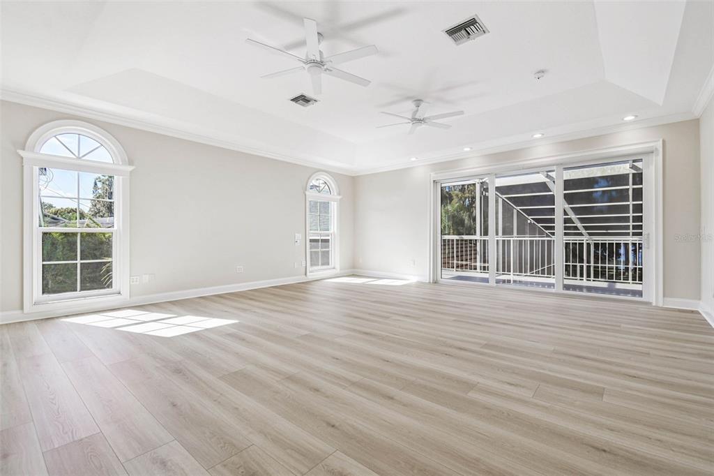 3505 Berger Road Lutz, FL 33548 - Photo 32 of 79 a view of an empty room with wooden floor and a window