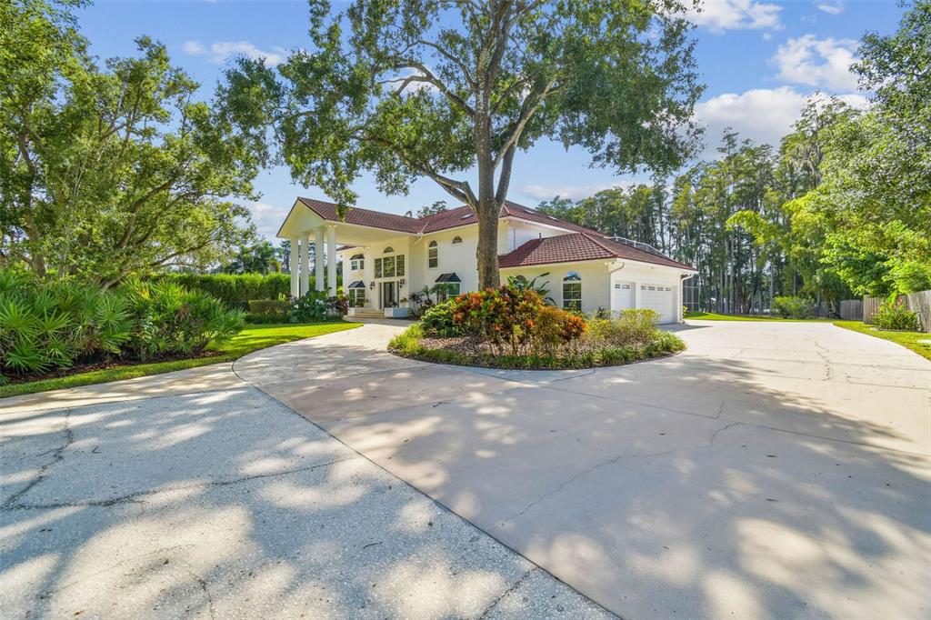 3505 Berger Road Lutz, FL 33548 - Photo 4 of 79 a front view of a house with a garden