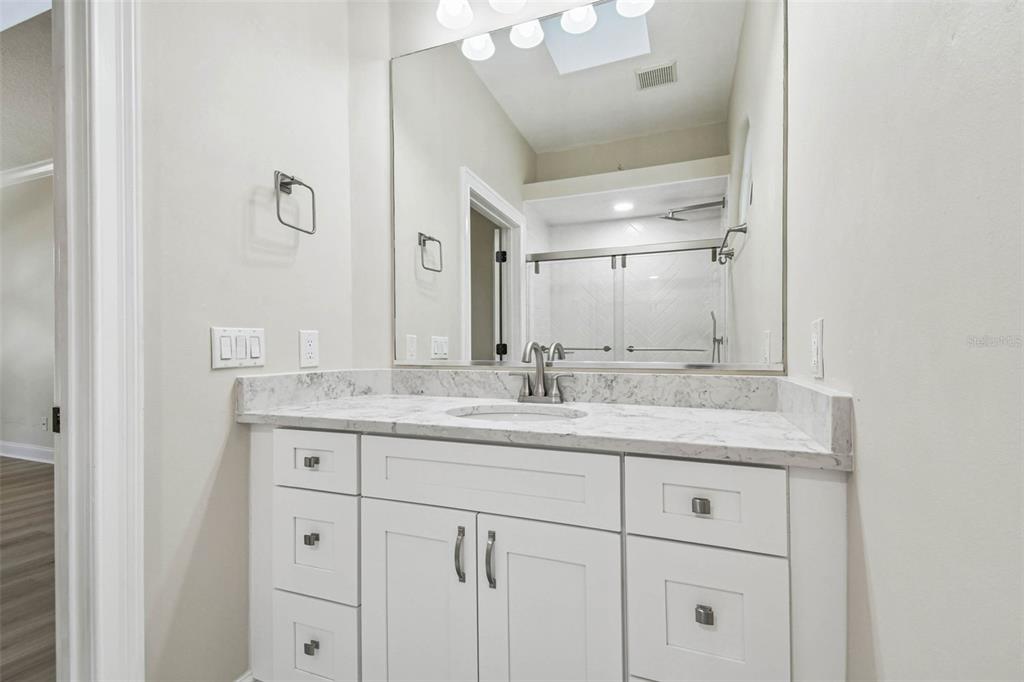 3505 Berger Road Lutz, FL 33548 - Photo 50 of 79 a bathroom with a granite countertop sink and a mirror