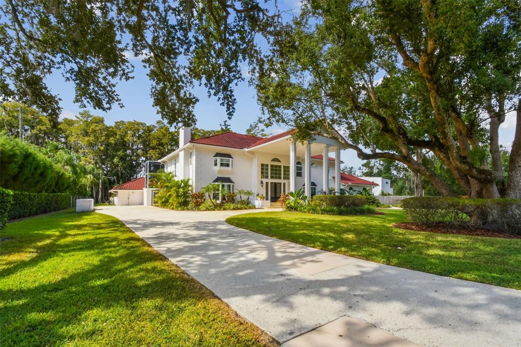 3505 Berger Road Lutz, FL 33548 - Photo 5 of 79 a front view of a house with a yard and trees
