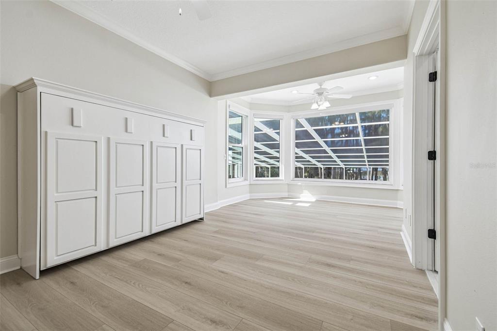 3505 Berger Road Lutz, FL 33548 - Photo 52 of 79 an empty room with wooden floor and windows