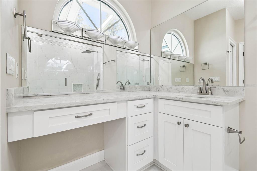 3505 Berger Road Lutz, FL 33548 - Photo 55 of 79 a bathroom with a granite countertop sink a large mirror a vanity and a window
