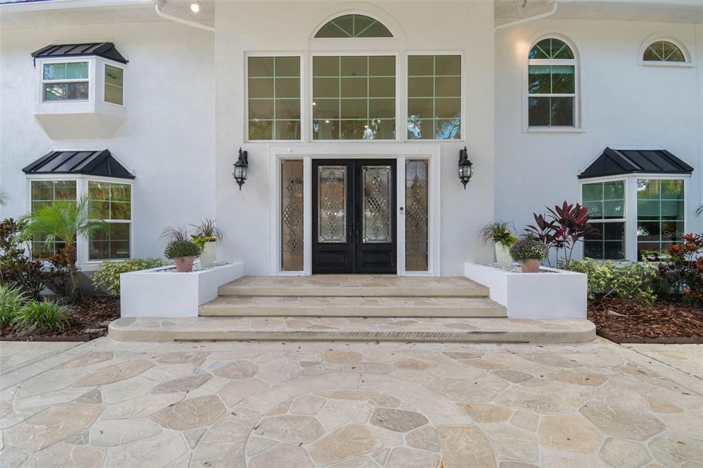 3505 Berger Road Lutz, FL 33548 - Photo 6 of 79 a front view of a house with a yard and potted plants