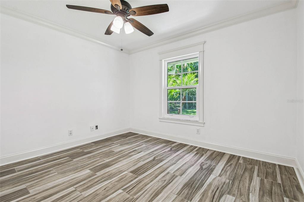 3505 Berger Road Lutz, FL 33548 - Photo 65 of 79 wooden floor in an empty room with a window