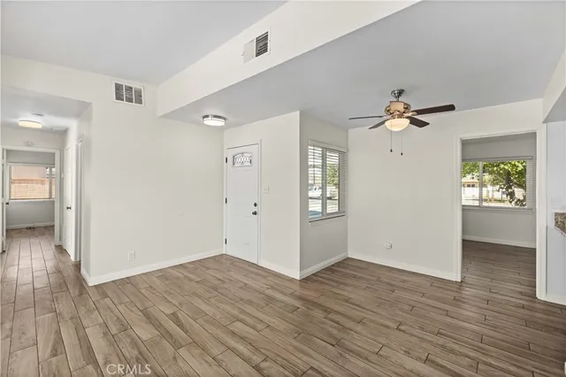 wooden floor in an empty room with a window