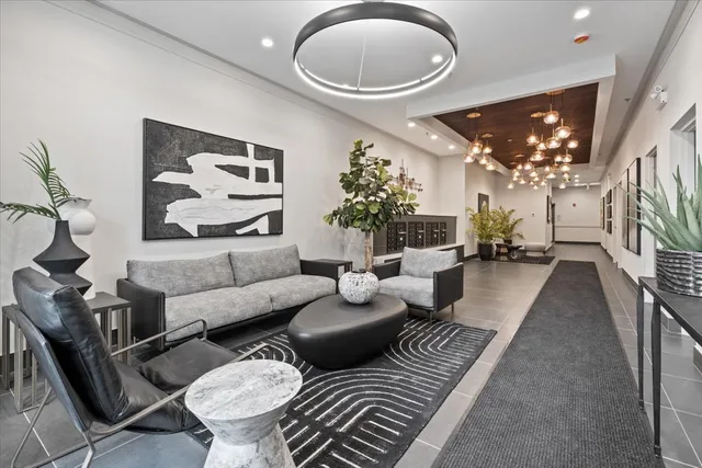a living room with furniture and a chandelier