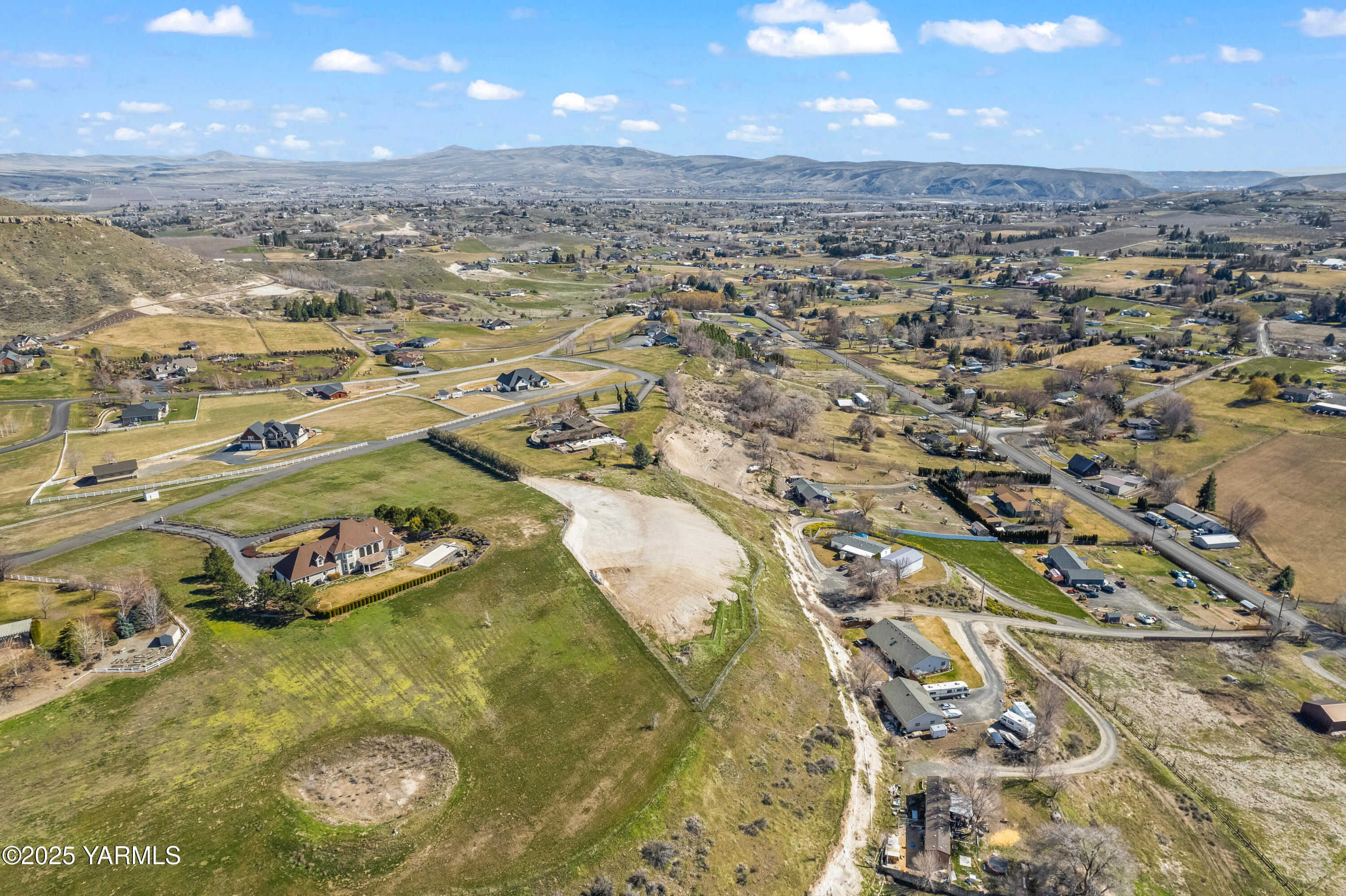an aerial view of a residential houses with outdoor space