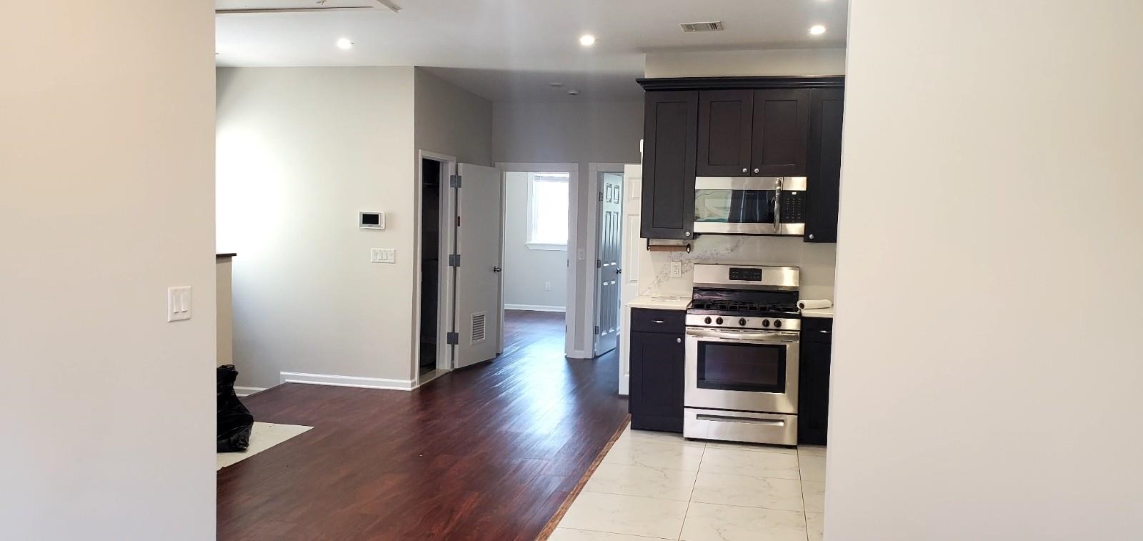 2110 Summit Avenue, Unit 2 Union City, NJ 07087 - Photo 3 of 11 a kitchen with stainless steel appliances granite countertop a stove and a refrigerator