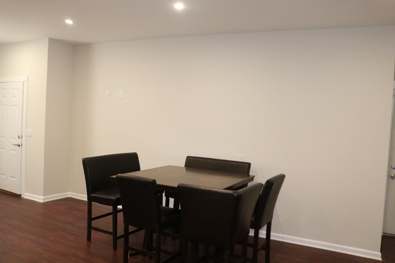 2110 Summit Avenue, Unit 2 Union City, NJ 07087 - Photo 4 of 11 a view of a dining room with furniture and wooden floor