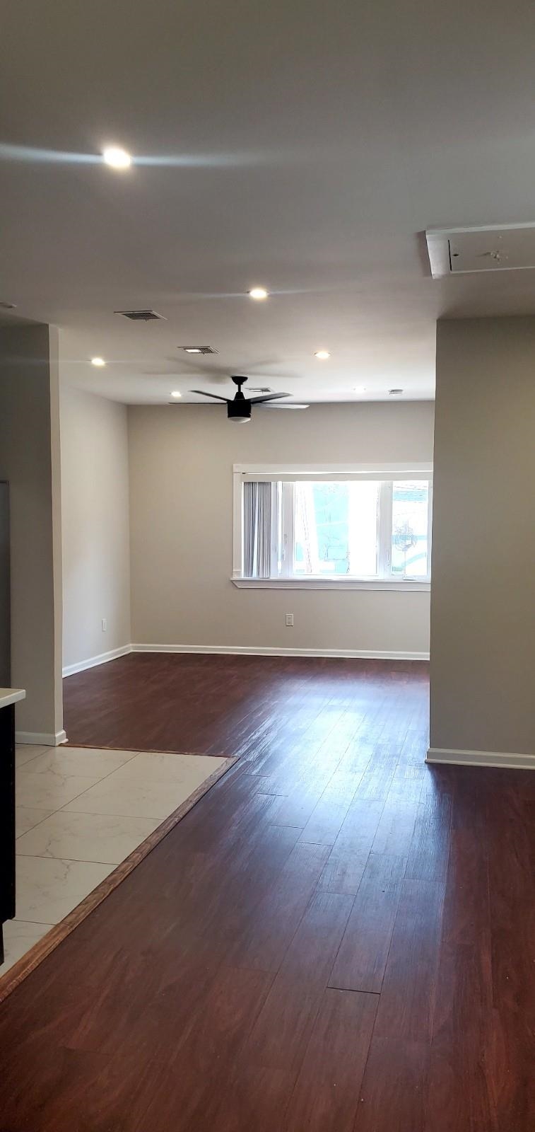 2110 Summit Avenue, Unit 2 Union City, NJ 07087 - Photo 5 of 11 an empty room with wooden floor and windows