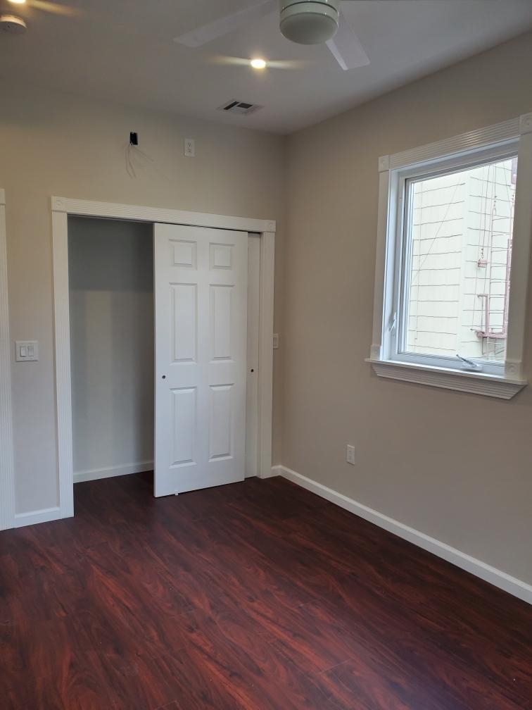 2110 Summit Avenue, Unit 2 Union City, NJ 07087 - Photo 6 of 11 an empty room with wooden floor and windows