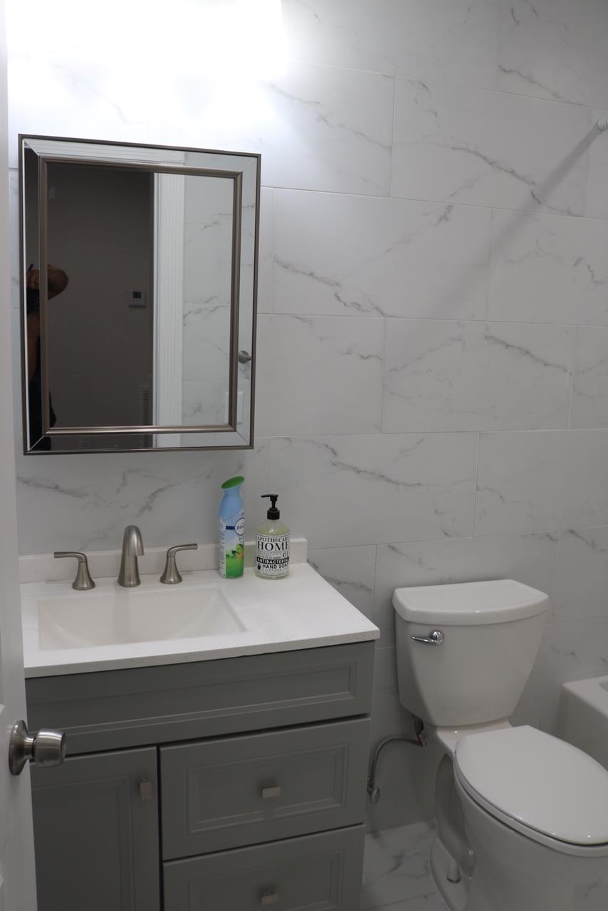 2110 Summit Avenue, Unit 2 Union City, NJ 07087 - Photo 7 of 11 a bathroom with a toilet sink and mirror