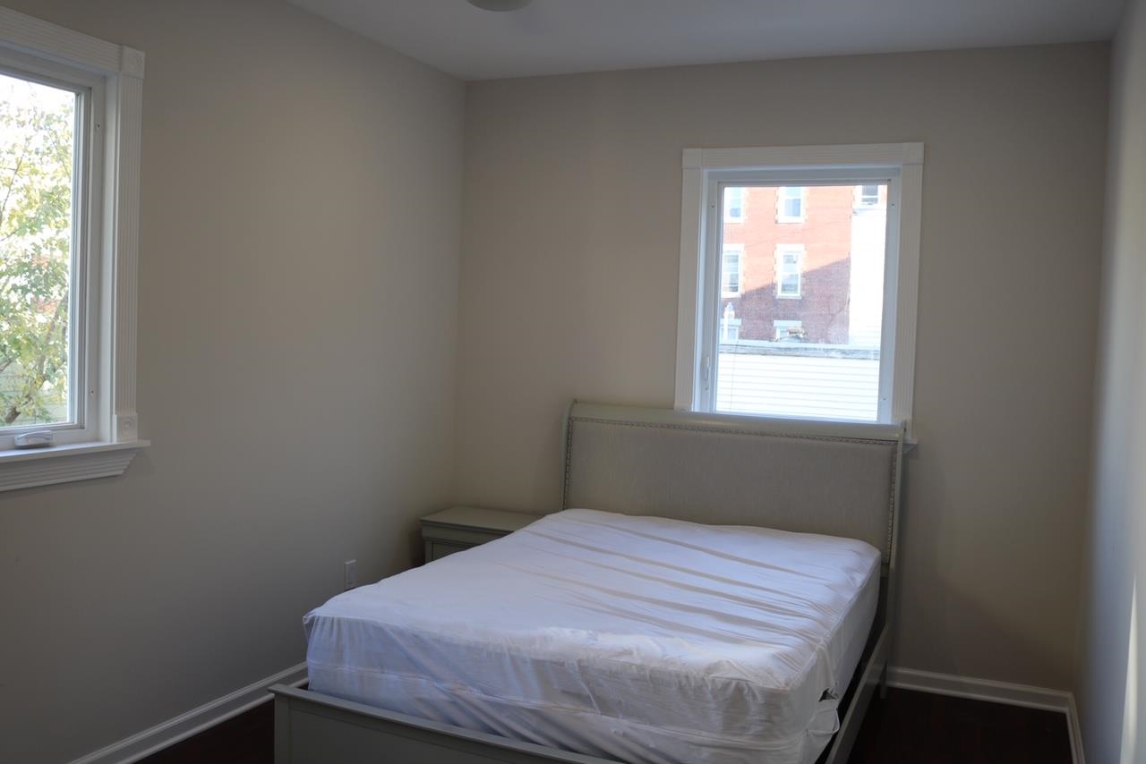 2110 Summit Avenue, Unit 2 Union City, NJ 07087 - Photo 9 of 11 a bedroom with a bed and a window