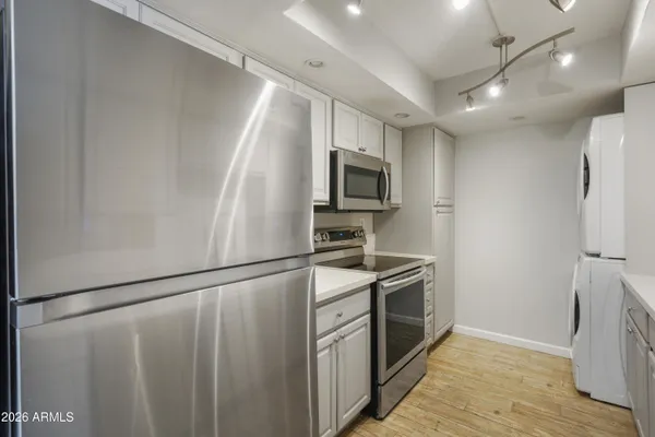 a kitchen with stainless steel appliances a refrigerator a stove top oven a sink and dishwasher