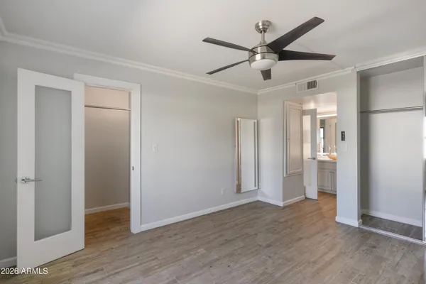 a view of a livingroom with wooden floor and a ceiling fan