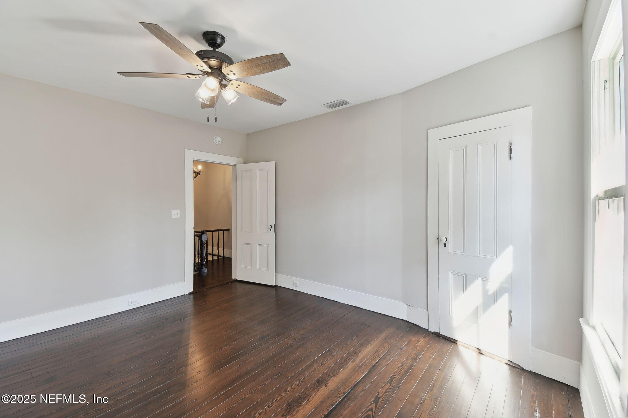 12277 Mandarin Road Jacksonville, FL 32223 - Photo 15 of 74 an empty room with wooden floor fan and windows
