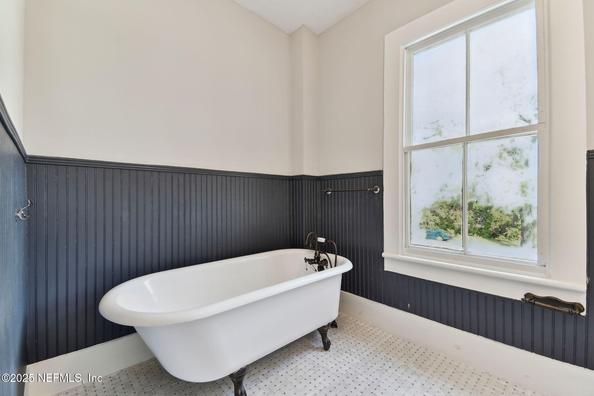 12277 Mandarin Road Jacksonville, FL 32223 - Photo 18 of 74 a bathroom with a bathtub and window