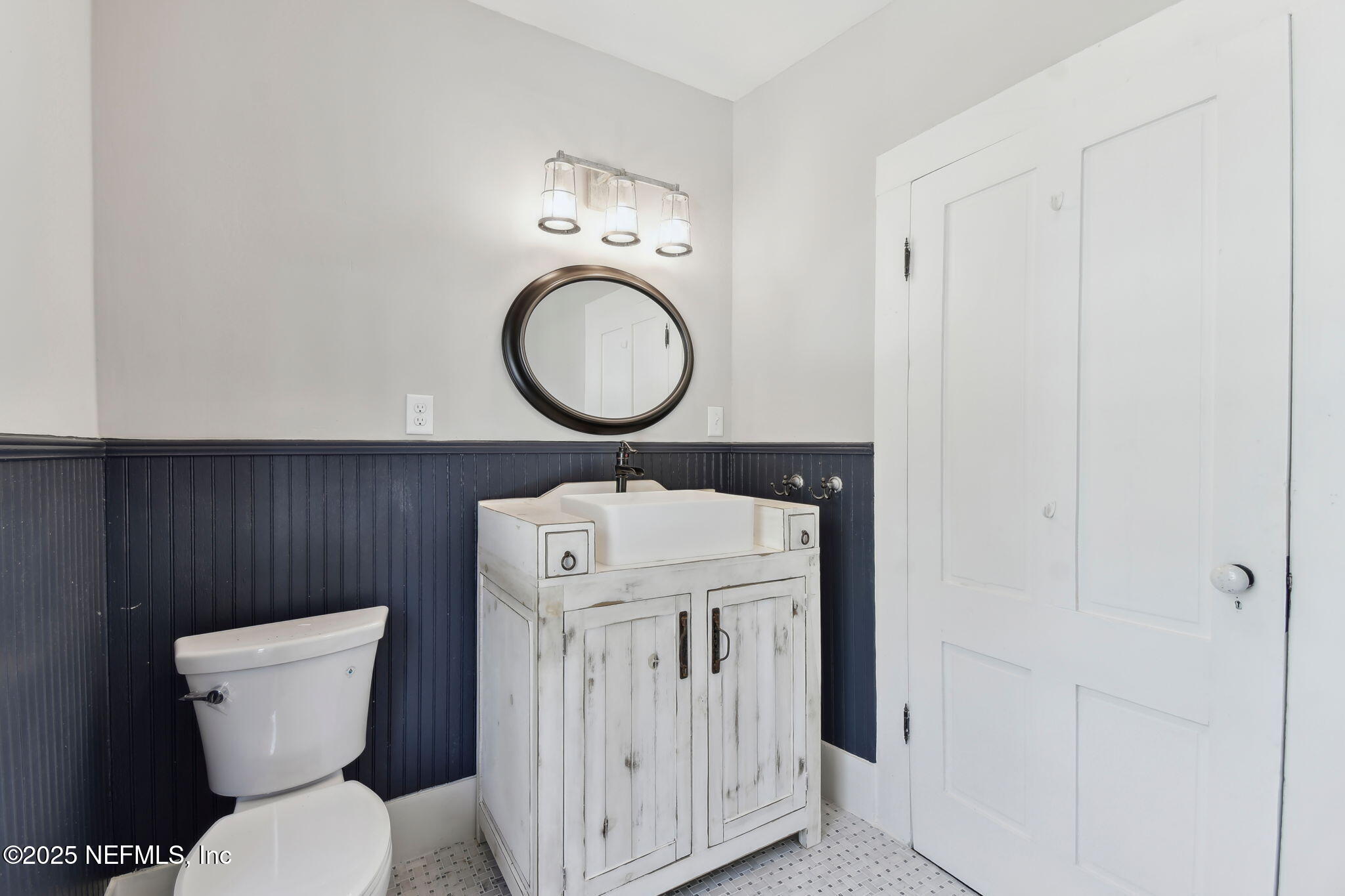 12277 Mandarin Road Jacksonville, FL 32223 - Photo 19 of 74 a bathroom with a toilet a sink and a mirror