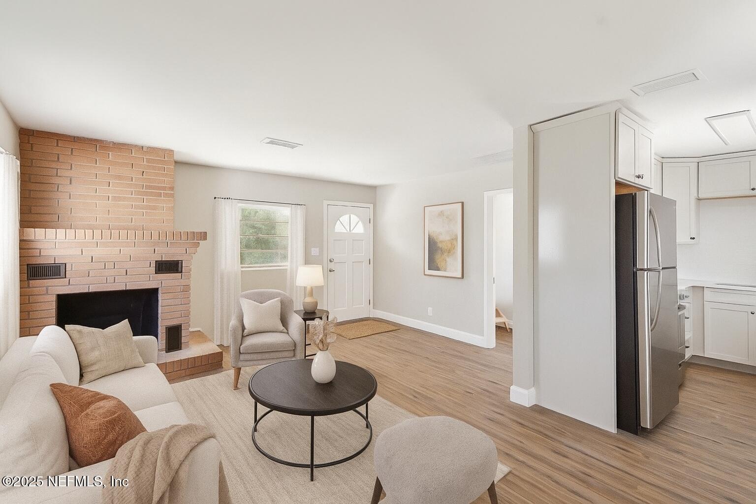 12277 Mandarin Road Jacksonville, FL 32223 - Photo 39 of 74 a living room with furniture and a fireplace