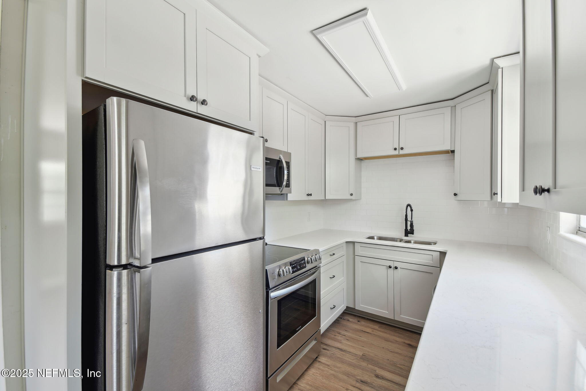 12277 Mandarin Road Jacksonville, FL 32223 - Photo 40 of 74 a kitchen with stainless steel appliances a refrigerator sink and cabinets
