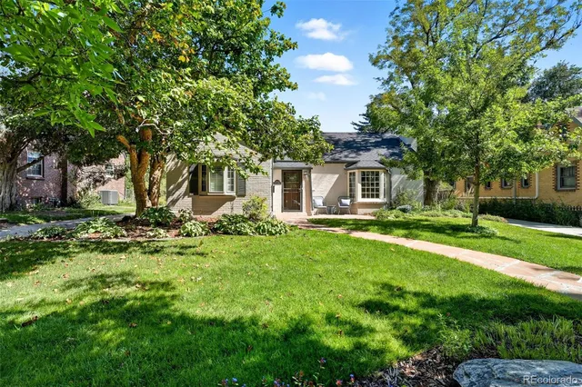 a front view of house with yard and green space