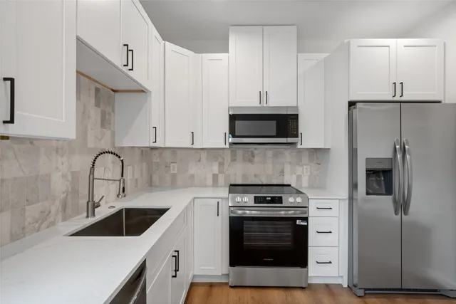 a kitchen with a sink stove and refrigerator