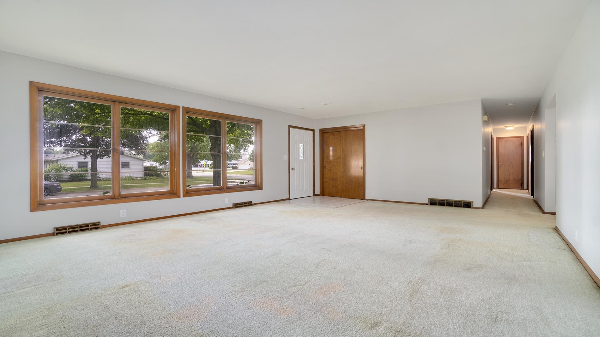 1202 Crest Lane Rochelle, IL 61068 - Photo 6 of 24 a view of a big room with windows and chandelier fan