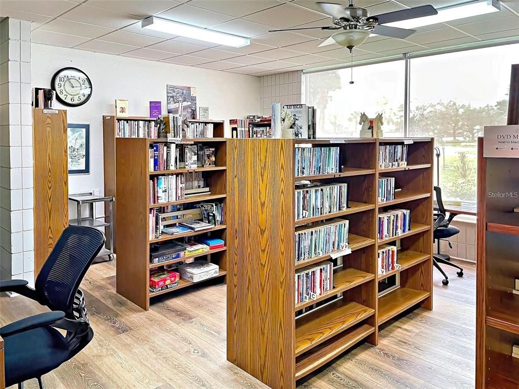 706 Roma Road Venice, FL 34285 - Photo 12 of 24 a view of a workspace with furniture and a book shelf
