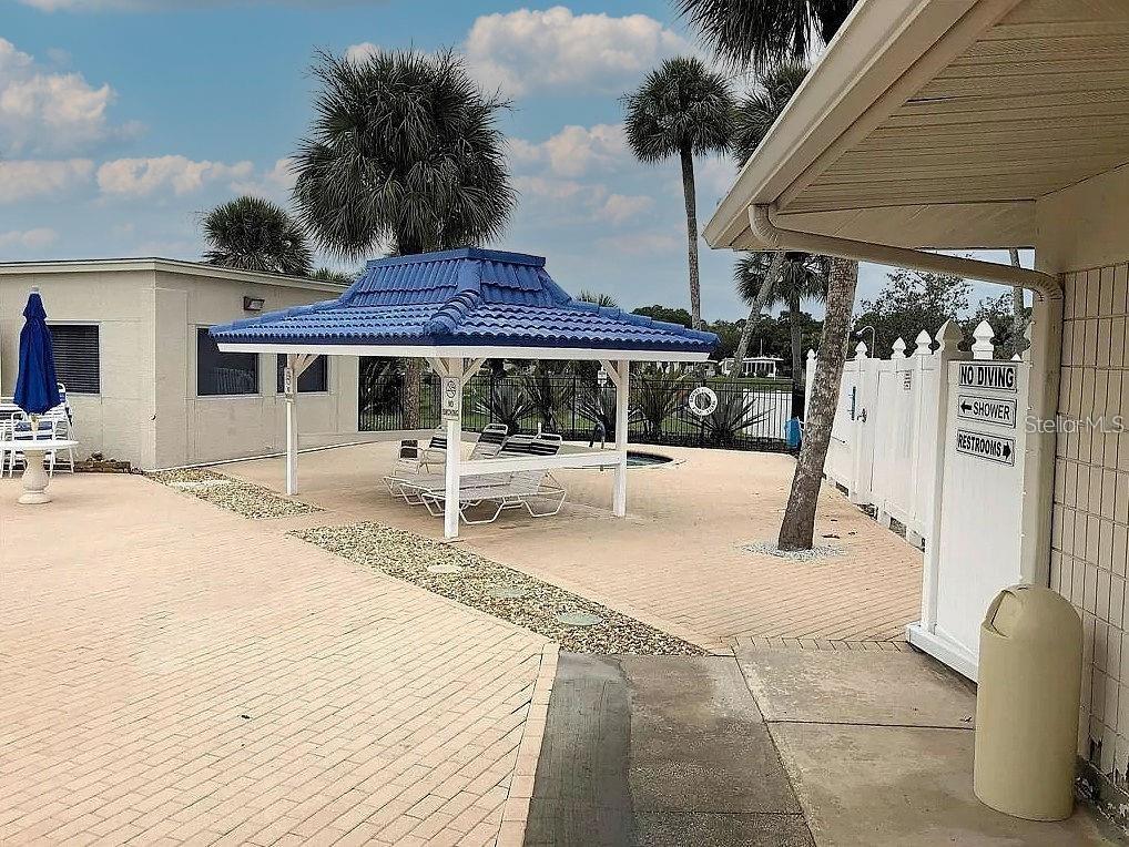 706 Roma Road Venice, FL 34285 - Photo 9 of 24 a patio with a table and chairs
