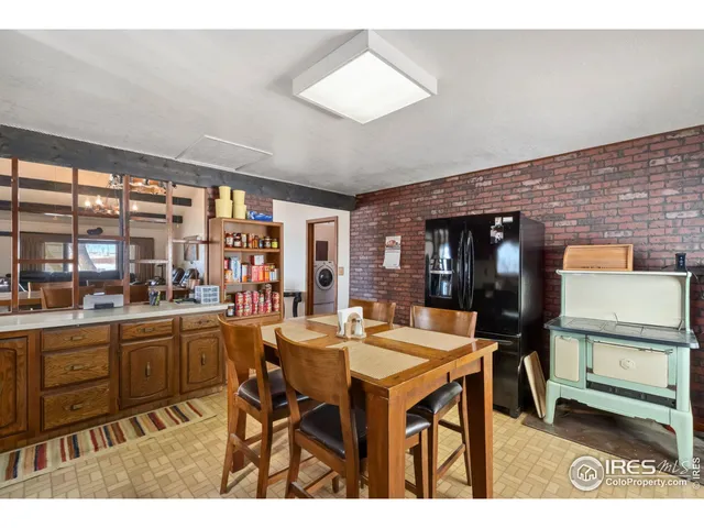 a living room with furniture a chandelier and a large window